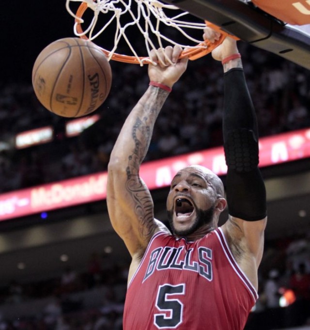Chicago Bulls power forward Carlos Boozer (5) slam dunks in the second half against the Miami Heat during Game 1 of their NBA Eastern Conference semi-final basketball playoff in Miami, Florida May 6, 2013. REUTERS/Joe Skipper 