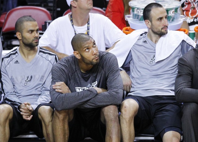 San Antonio Spurs' Tony Parker (L), Tim Duncan (C), and Manu Ginobili sit on the bench during their loss to the Miami Heat in Game 2 of their NBA Finals basketball playoff in Miami, Florida June 9, 2013. REUTERS/Joe Skipper 