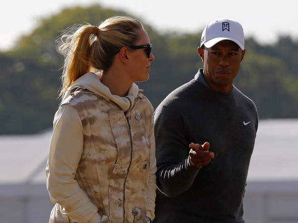 Tiger Woods of the U.S. walks with his girlfriend skier Lindsey Vonn 