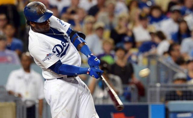 Hanley Ramirez (13) hits a triple in the fourth inning against the Atlanta Braves in game three of the National League divisional series playoff baseball game at Dodger Stadium. Credit: Robert Hanashiro-USA TODAY Sports