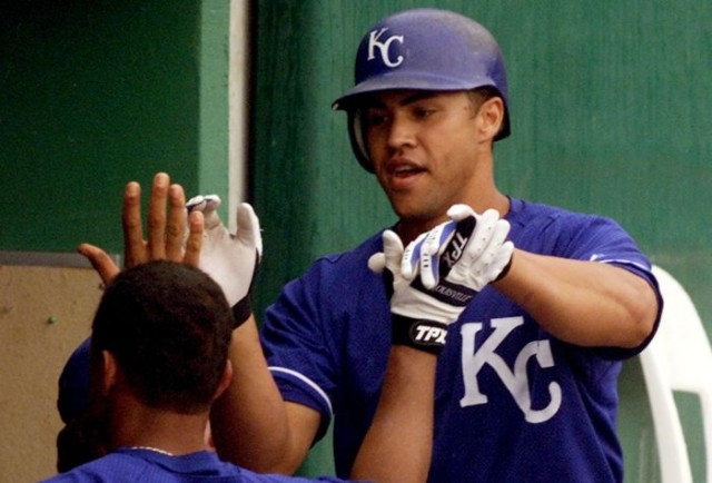 Kansas City Royals center fielder Carlos Beltran (R), who was born in Manaiti, Puerto Rico, is congratulated by teammates including Luis Alicea after Beltran hit a solo home run off of New York Yankees Scott Kamieniecki during a spring training game in Haines City, Florida March 13, 2001. 