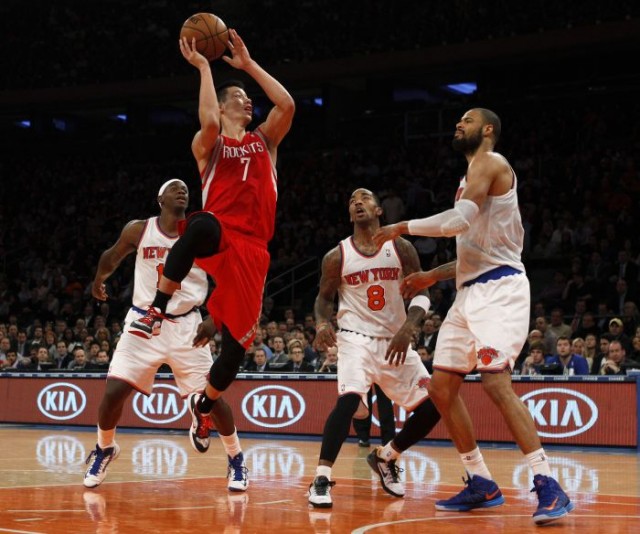 Houston Rockets Lin shoots defended by Knicks Chandler, Smith and Brewer in NBA basketball game in New York. 