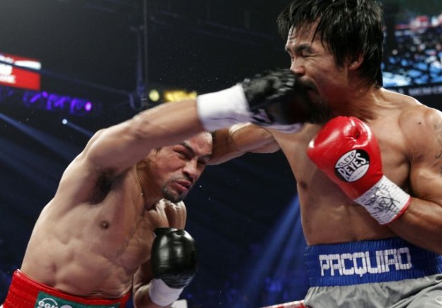 Pacquiao hit hard by Marquez with overhand right. 