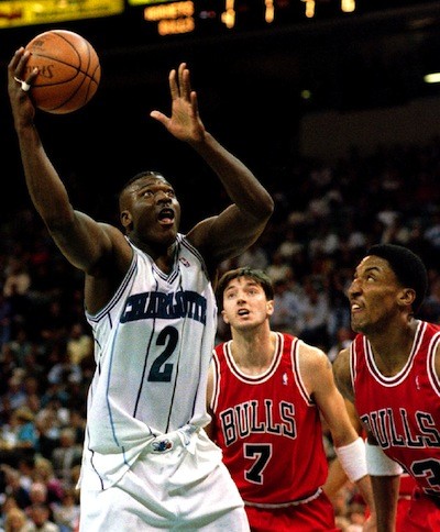 Charlotte Hornets' forward Larry Johnson (2) drives past Chicago Bulls' forwards Tony Kukoc and Scottie Pippen (R) during first half NBA action, February 20, 1995 at the Charlotte Coliseum.