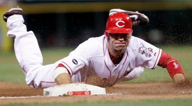 Cincinnati Reds' Joey Votto slides in safe at third base