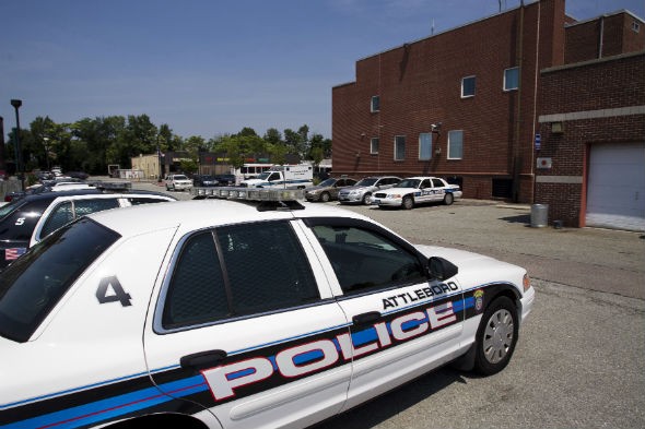 Police cruisers sit in the parking lot of the police station in Attleborough