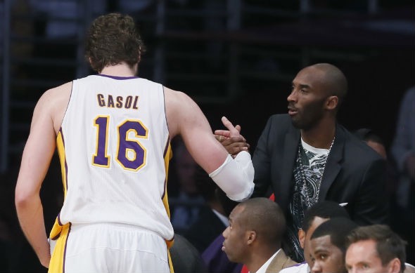 Los Angeles Lakers Pau Gasol of Spain (L) shakes hands with injured guard Kobe Bryant