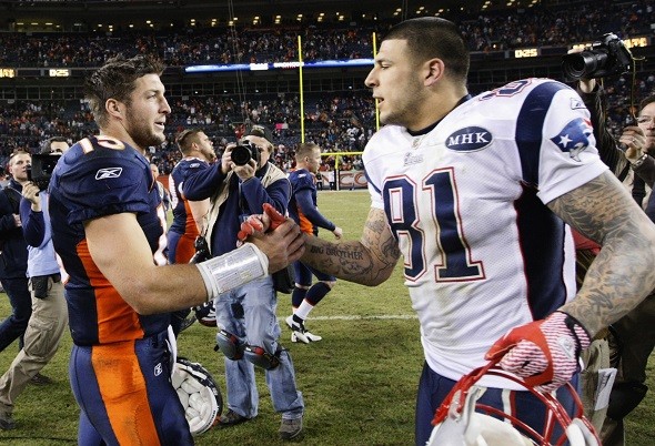 Denver Broncos quarterback Tim Tebow shakes hands with New England Patriots tight end Aaron Hernandez