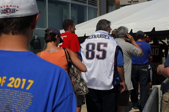 Fans wait in line to exchange jerseys of former New England Patriots player Aaron Hernandez