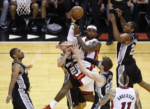 Miami Heat's LeBron James (6) is surrounded by San Antonio Spurs' Gary Neal 