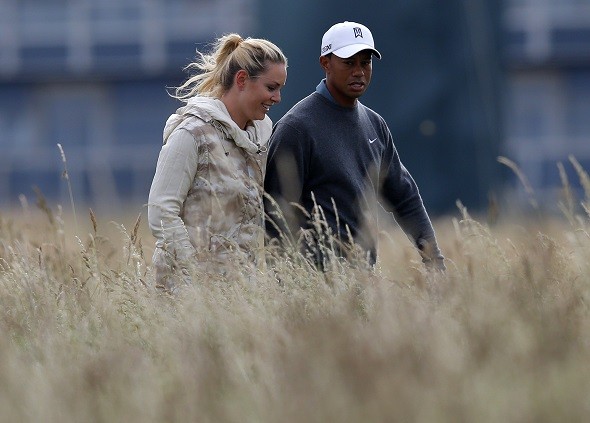 Tiger Woods of the U.S.walks with his girlfriend skier Lindsey Vonn