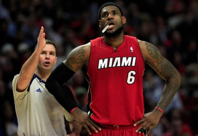 Miami Heat's LeBron James (R) looks on