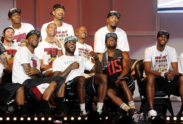 Miami Heat players laugh as a video of Chris Bosh
