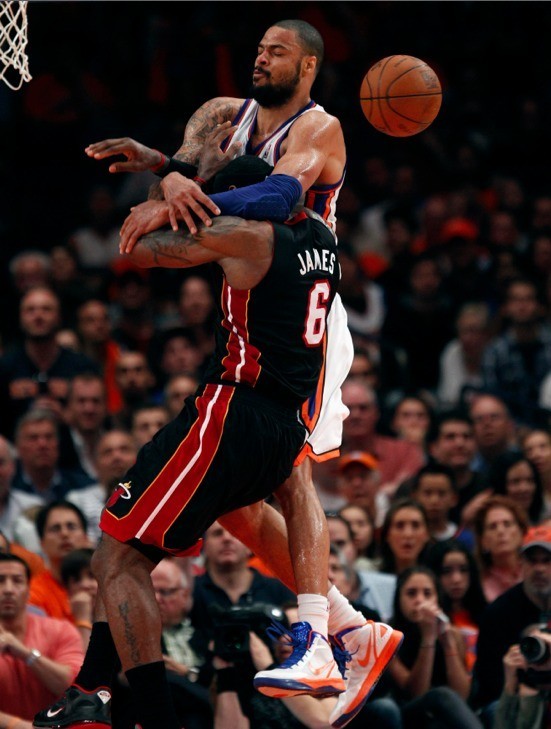 Miami Heat's LeBron James (6) is fouled by New York Knicks' Tyson Chandler in the second half during their NBA basketball game in New York, April 15, 2012.