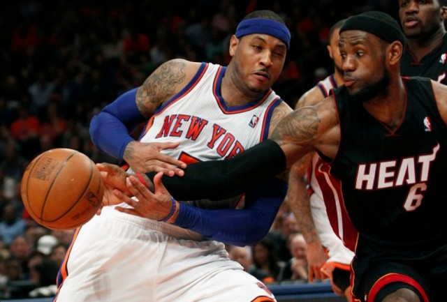 Miami Heat's LeBron James (R) reaches in to poke the ball away from New York Knicks' Carmelo Anthony in the second half of their NBA basketball game in New York, April 15, 2012. 