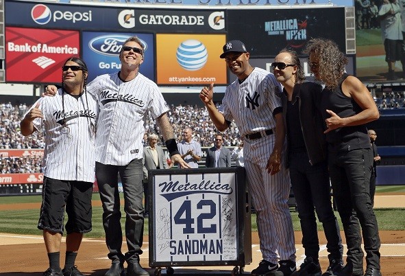 New York Yankees relief pitcher Mariano Rivera reacts to a gift of a guitar speaker from the band Metallica
