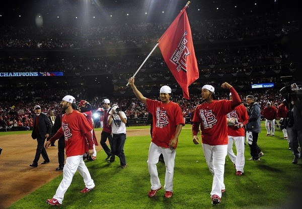 St. Louis Cardinals players from left Daniel Descalso , Carlos Martinez and Jon Jay celebrate