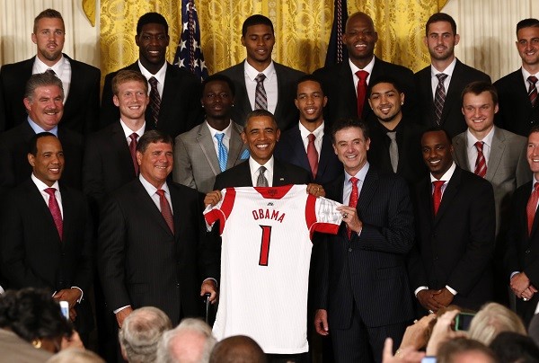 U.S. President Barack Obama holds a Louisville Cardinals basketball