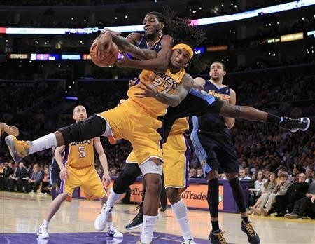 Los Angeles Lakers' Jordan Hill fights for a rebound with Denver Nuggets' Kenneth Faried (front) during Game 7 of their NBA Western Conference basketball playoff series in Los Angeles
