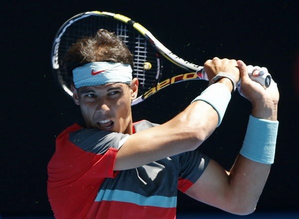 Rafael Nadal of Spain hits a return to Grigor Dimitrov
