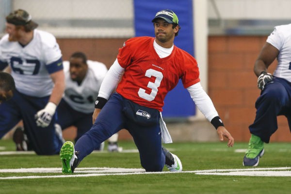 Seattle Seahawks quarterback Russell Wilson stretches at their NFL Super Bowl XLVIII
