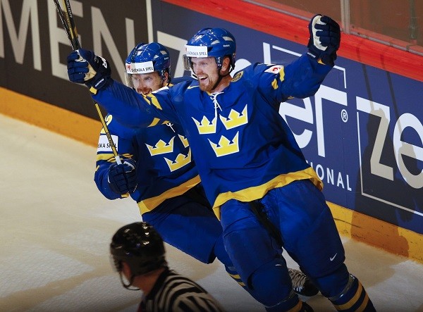 Sweden's Daniel Sedin celebrates with team mate Henrik Sedin