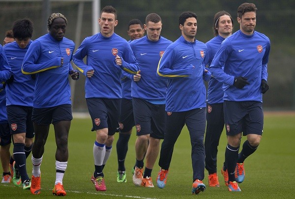Arsenal team members led by Olivier Giroud 