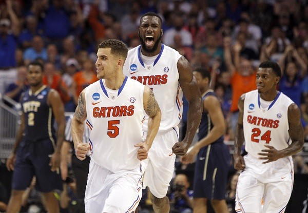  Florida Gators center Patric Young (center) reacts after guard Scottie Wilbekin