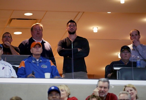 Tim Tebow watches the game between the Florida Gator