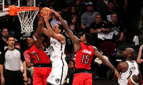 Toronto Raptors guard Kyle Lowry (7) and Toronto Raptors forward Amir Johnson (15) defend against Brooklyn Nets guard Shaun Livingston (14) in the second half of game four of the first round of the 2014 NBA Playoffs at the Barclays Center. 