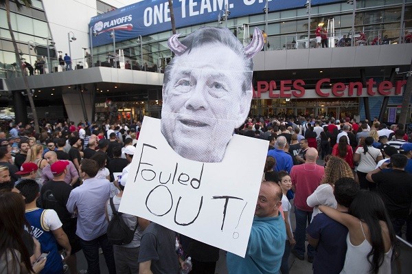 A supporter holds a photo cutout of Los Angeles Clippers owner Donald Sterling