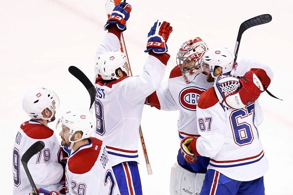The Montreal Canadiens surround goalie Carey Price