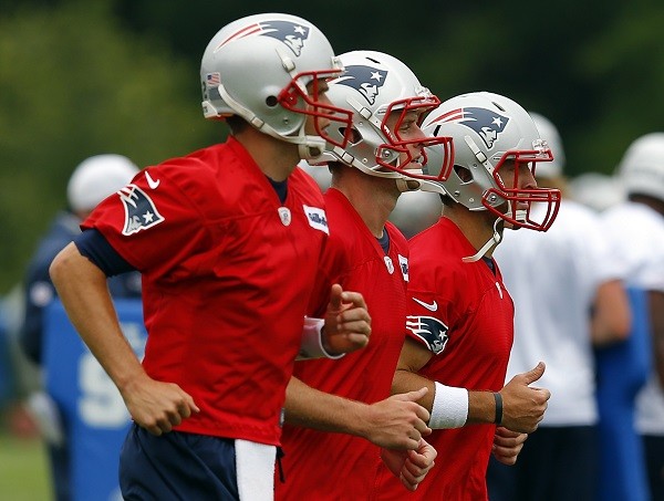 New England Patriots quarterbacks Tom Brady (L), Ryan Mallett (C) and Tim Tebow 