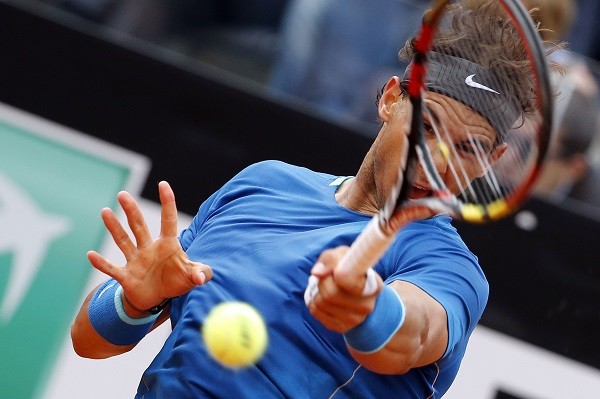 Rafael Nadal of Spain hits a return to Novak Djokovic 
