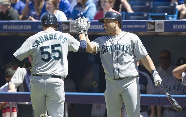 Seattle Mariners Michael Saunders (L) is congratulated by teammate Kendrys Morales