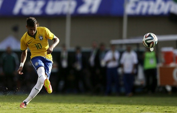 Neymar of Brazil kicks to scores