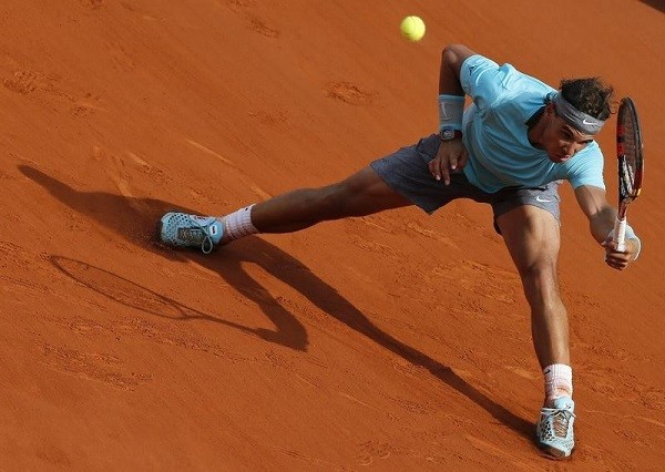Rafael Nadal of Spain returns the ball to Novak Djokovic 
