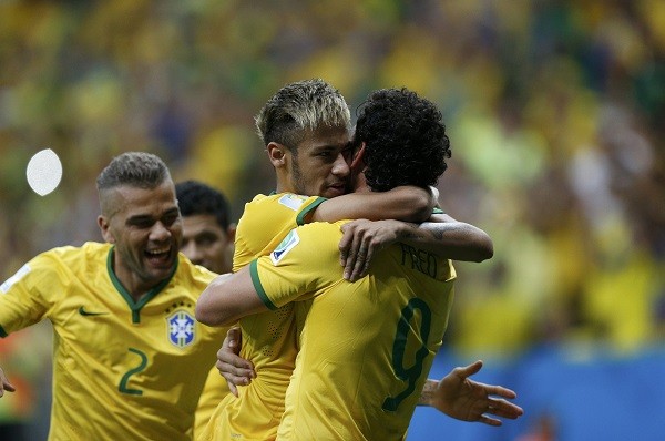 Brazil's Fred (R) celebrates his goal against Cameroon with teammates Neymar 