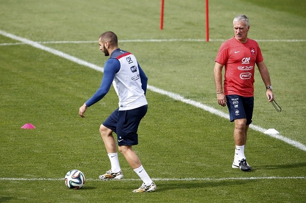 France's national soccer team head coach Didier Deschamps (R) watches as Karim Benzema