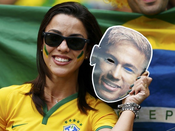 A fan of Brazil holds up a Neymar cut-out mask 