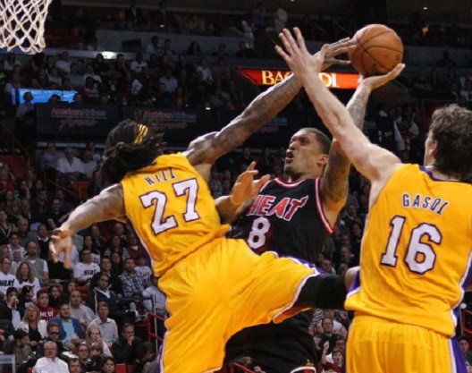 The Miami Heat's Michael Beasley goes to the basket against the Los Angeles Lakers' Jordan Hill 