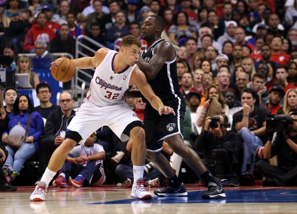 Blake Griffin #32 of the Los Angeles Clippers drives against Andray Blatche 