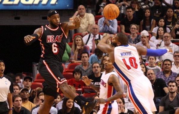 Miami Heat's LeBron James fights a rebound with Detroit Pistons' Greg Monroe