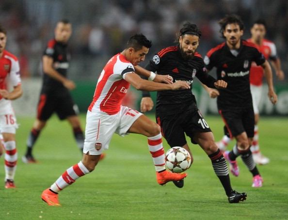  Alexis Sanchez of Arsenal takes on Olcay Sahan 