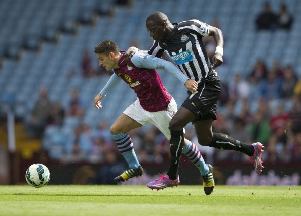Ashley Westwood of Aston Villa is challenged by Moussa Sissoko of Newcastle United