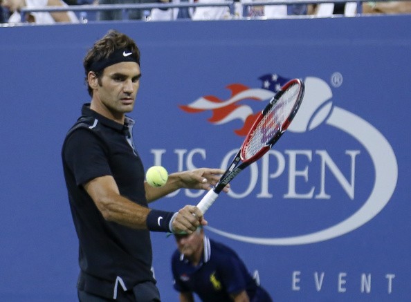 Roger Federer of Switzerland returns the ball to Gael Monfils