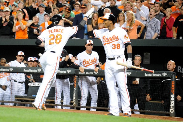 Jimmy Paredes #38 of the Baltimore Orioles congratulates Steve Pearce #28