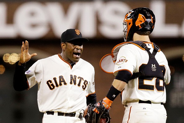 Santiago Casilla #46 and Buster Posey #28 of the San Francisco Giants 