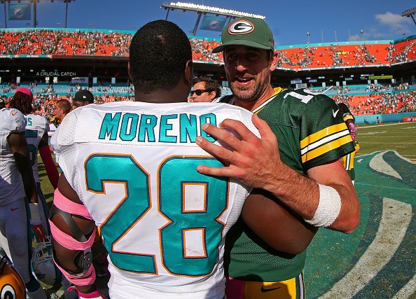 Aaron Rodgers #12 of the Green Bay Packers Knowshon Moreno #28 of the Miami Dolphins