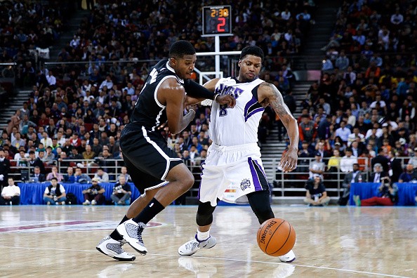 Rudy Gay #8 of Sacramento Kings drives against Joe Johnson of Brooklyn Nets